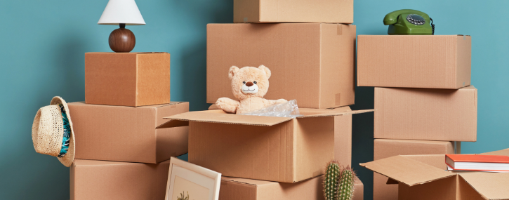 stacks of moving boxes against a teal colored wall