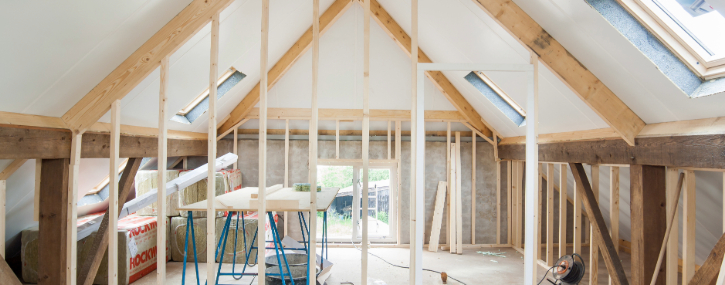 an interior room is under renovation with new wall framing and flooring