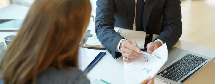 a mortgage loan officer is reviewing details with clients