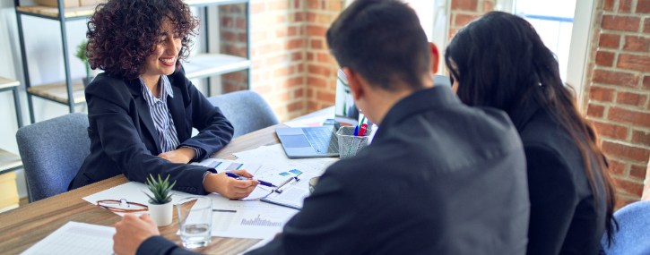 two people are meeting with a mortgage loan officer