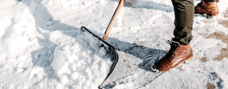 Someone shoveling snow off a walk path